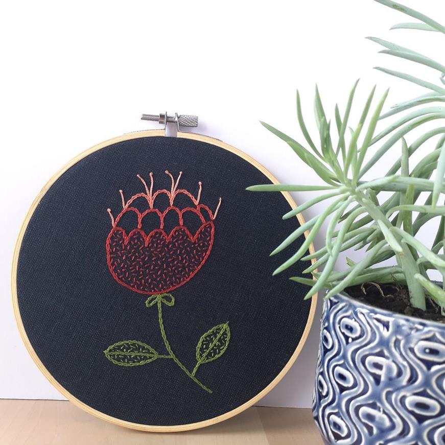 Hoop art - hand embroidered pictures 3 Red abstract flower hand embroidered hoop on navy blue fabric near a succulent plant