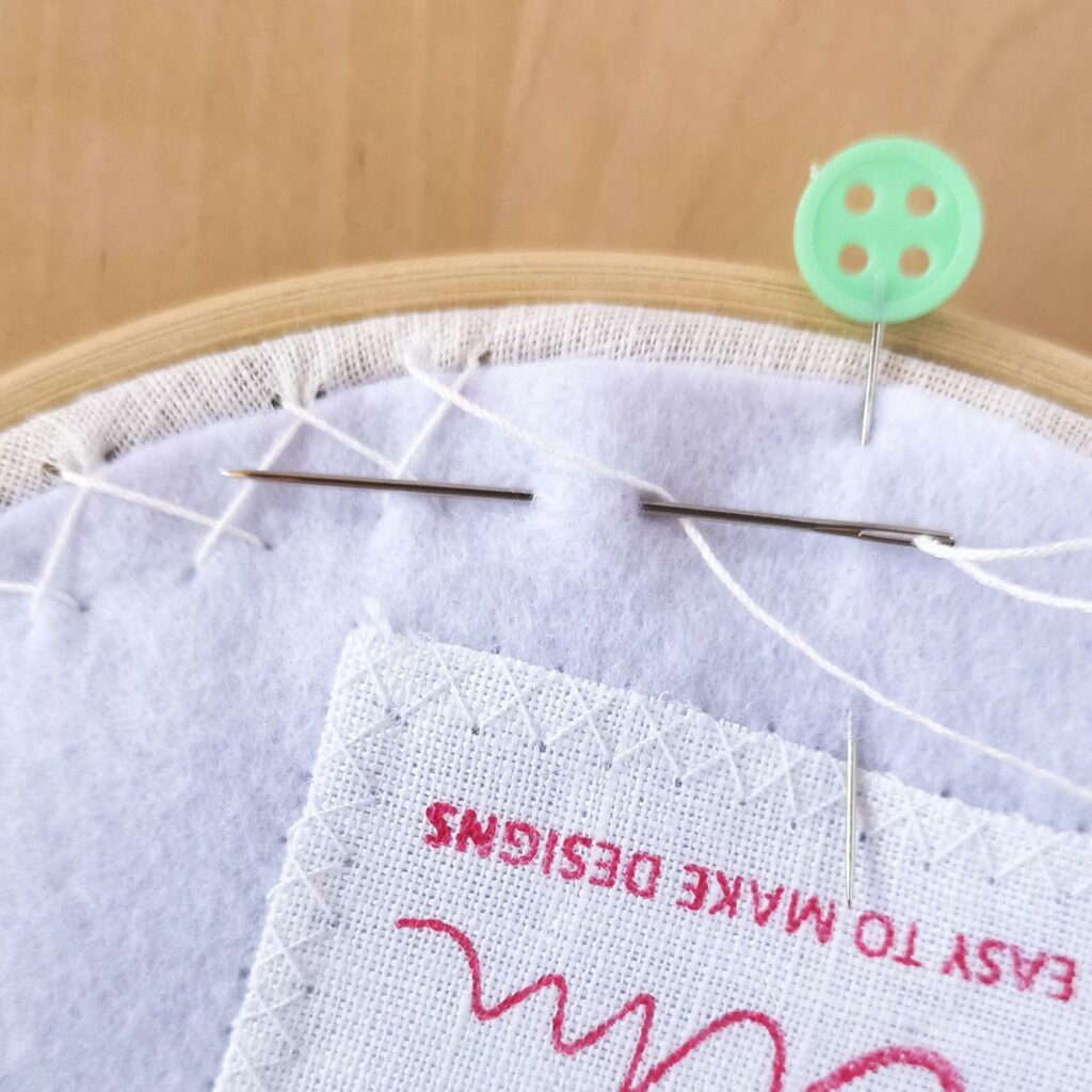 Backing the hoop with felt and herringbone stitch